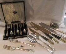 A cased set of 6 cake forks, a carving set, other cutlery and place card holders.