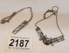A silver necklace and a silver pendant.