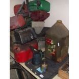 A quantity of oil cans and jug including 2 gallon fuel can, funnels etc.