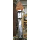 A chrome plated mortar bomb table lamp with flame glass shade.