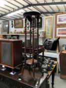 A dark wood stained plant stand/hall table