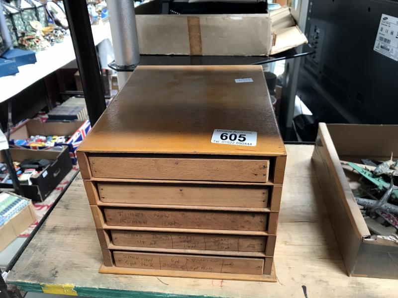 A 5 drawer chest of metal letter punches