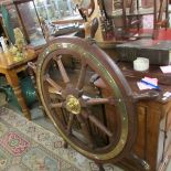 A large old wood and brass ship's wheel.