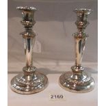 A pair of hall marked silver candlesticks, hall mark rubbed.