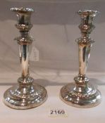 A pair of hall marked silver candlesticks, hall mark rubbed.