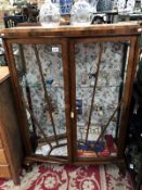 An art deco display cabinet with sun burst design doors