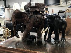 A large carved wood elephant stand & 4 smaller carved elephants