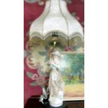 A figural table lamp with shade.