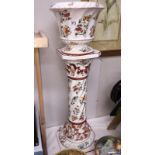 A Capodimonte jardiniere and stand with floral decoration