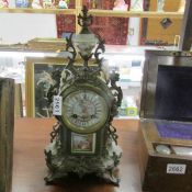 A French mantle clock with enamel dial and porcelain panel.