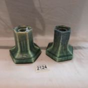 A pair of Ruskin art pottery candlesticks.