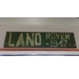 A painted wooden sign 'Land Rover 1947'