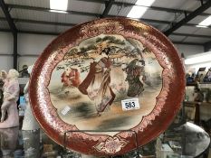 A large plate with oriental figure design