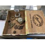 An old cigar box containing badges, medals, buckles & button etc.