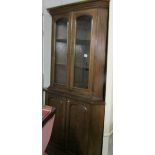 A freestanding mahogany corner cupboard with glazed top.