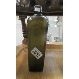 A cast green glass bottle inscribed 'V. Hoytema & Co.