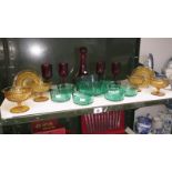 A quantity of glass items including a red glass decanter with 4 wine glasses,