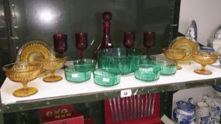 A quantity of glass items including a red glass decanter with 4 wine glasses,