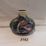 A Moorcroft squat vase, approximately 4.25" tall.