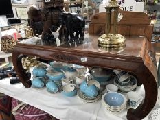 An oriental design coffee table with glass cover