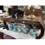 An oriental design coffee table with glass cover