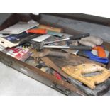 A box of wood working tools including saws and blades