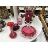 A quantity of cranberry glass items including vase