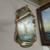 A gilt framed mirror.