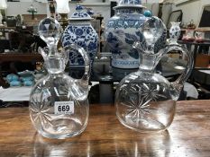 2 glass jugs with stoppers