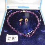 A cased 14ct gold and amethyst necklace and earrings.