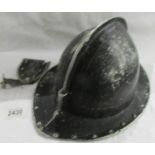 A fireman's helmet (no liner) with ID tag holder.