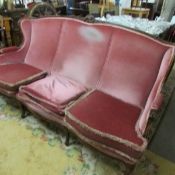 A 3 seat wing sofa.