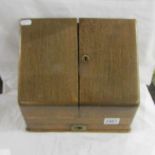 An oak desk top stationary cabinet.