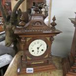 An oak cased mantel clock (missing glass).