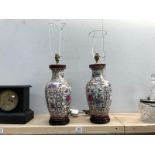 A pair of 20th Century ceramic table lamps in the style of vases with gilt and floral decoration