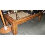 A dark stained coffee table with wicker inset A/F
