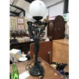 A figural table lamp of an art deco style lady