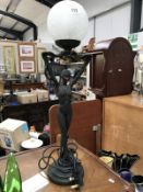 A figural table lamp of an art deco style lady