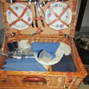 A picnic set in wicker basket.