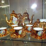A gold decorated coffee set.