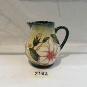 A 2002 limited edition signed Moorcroft jug, 65/250, approximately 4.5" tall.