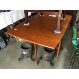 A teak drop leaf dining table