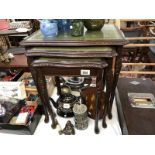 A nest of 3 small tables each having embossed green leather inlays under glass