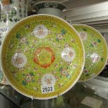 A pair of yellow ground Chinese plates (a/f chipped).
