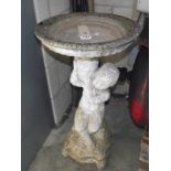 A garden water feature/bird bath of cherub with urn