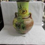 A large Doulton & Slater patent vase decorated with hand painted sunflowers.
