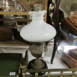 A brass oil lamp with shade,