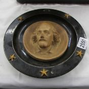 A slipware glazed plaque depicting William Shakespeare, a/f.