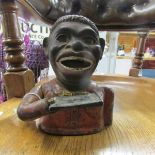 A period cast iron money box of a racialised caricature of an African-American male.