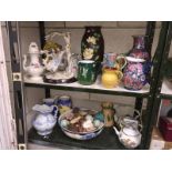 2 shelves of porcelain including jugs, teapots etc.